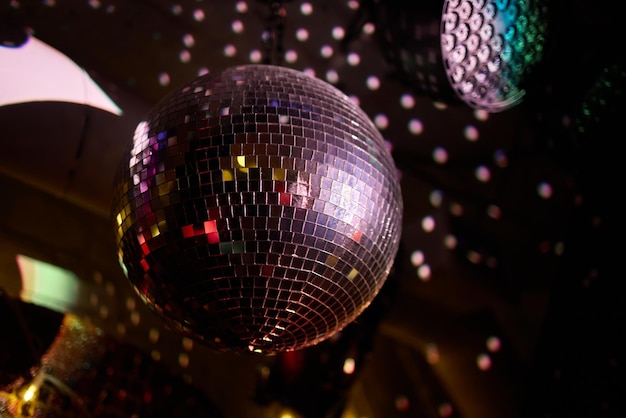 Colorful disco mirror ball lights night club background