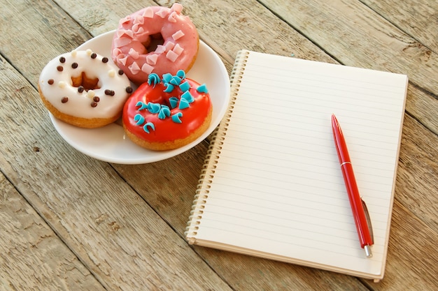 Colorful donuts and notepad