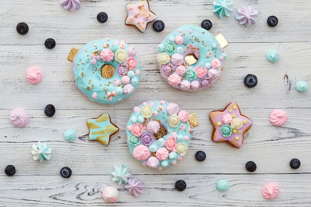 Colorful donuts on white wooden wall