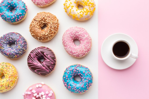 Colorful donuts with coffee top view