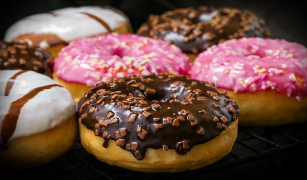 Colorful doughnuts on a dark, a festive dessert