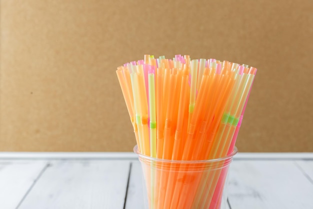 Colorful drinking straws in a plastic cup The problem of environmental pollution