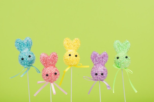 Colorful Easter bunnies on a green background.