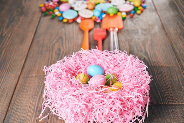 Colorful easter cookies and nest with eggs.