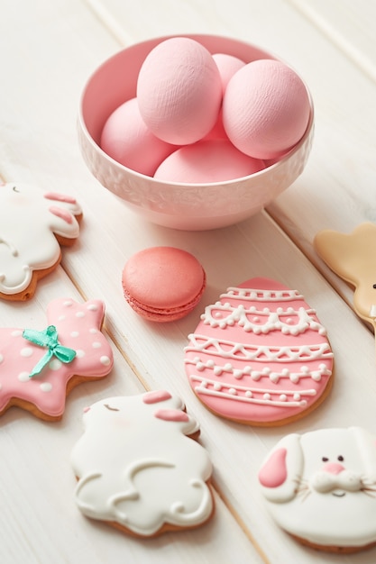 Colorful easter cookies and pink eggs