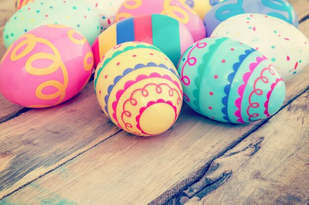 Colorful easter egg on wood background with space