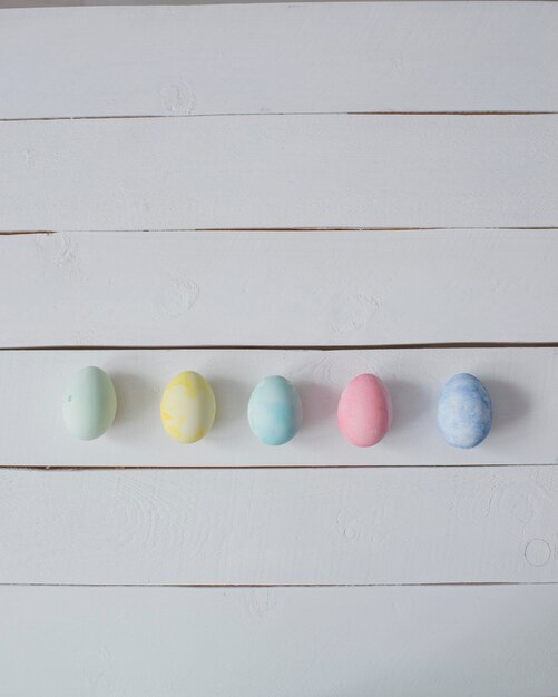 Colorful Easter eggs are lying on the table