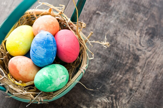 Colorful easter eggs in a basket  copy space