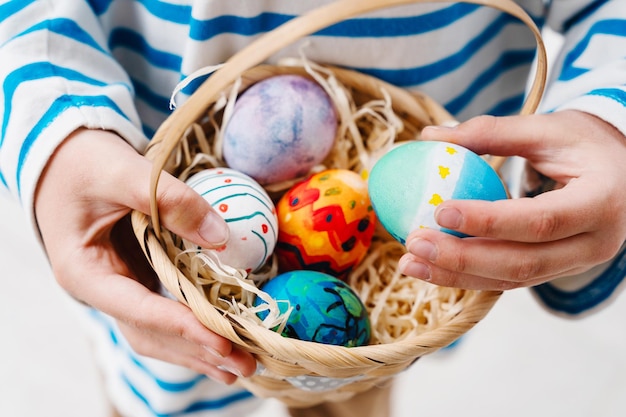 Colorful Easter eggs in basket Kids hunt for eggs outdoors