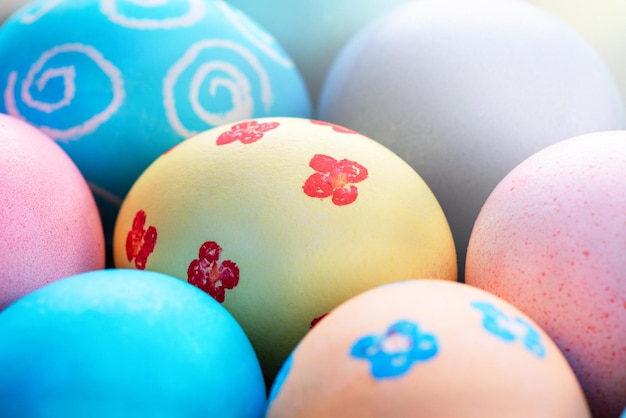 Colorful Easter eggs dyed by colored water with beautiful pattern on a pale blue background design concept of holiday activity top view full frame