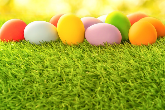 Colorful Easter eggs on green grass