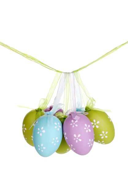 Photo colorful easter eggs hanging on ribbons isolated on white