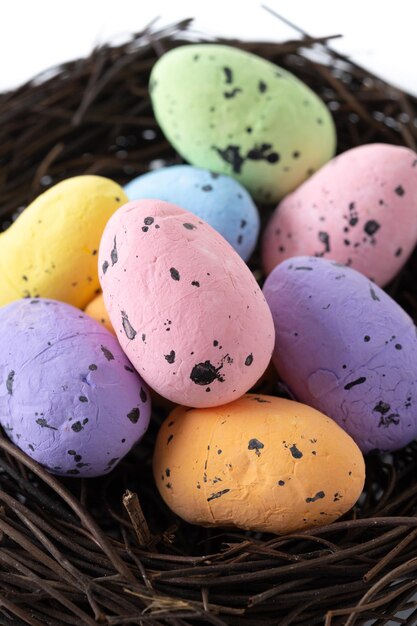 Colorful Easter eggs inside a nest isolated on white background