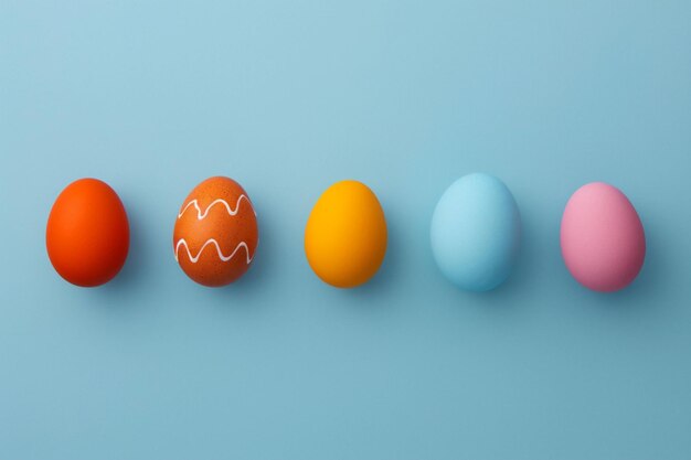 Colorful Easter Eggs in Minimalist Style on a Blue Background A vibrant array of Easter eggs with a minimalist design neatly arranged against a clear blue background with ample copy space