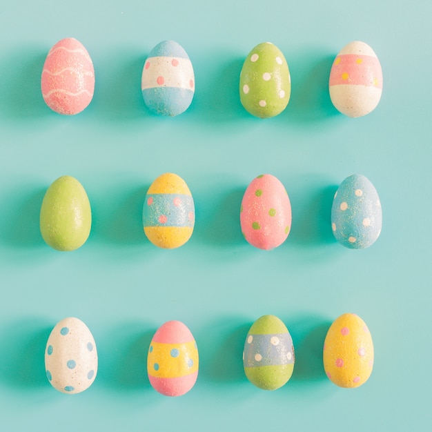 Colorful easter eggs on pastel color background with space.