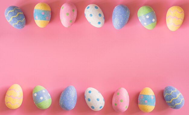 Colorful easter eggs on pink pastel color background