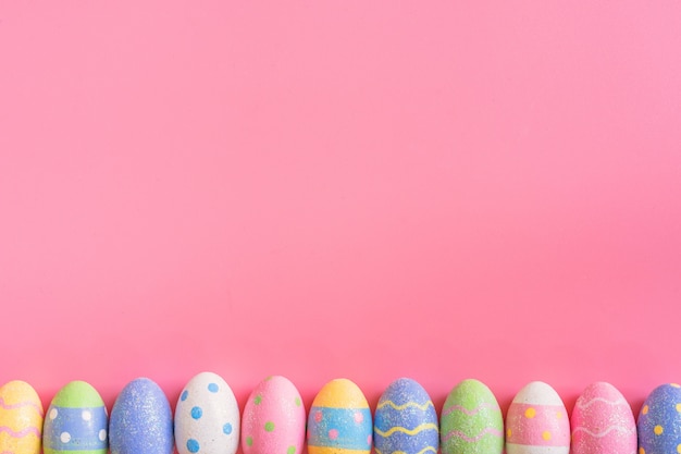 Colorful easter eggs on pink pastel color background