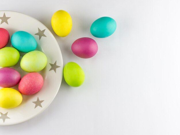 Colorful Easter eggs in a plate with space for text