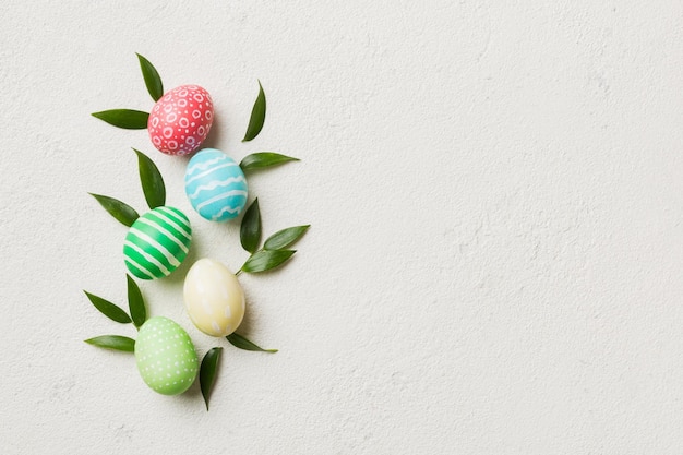 Photo colorful easter eggs with spring flower leaf isolated over white background colored egg holiday border