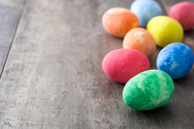 Colorful easter eggs on wooden table copy space