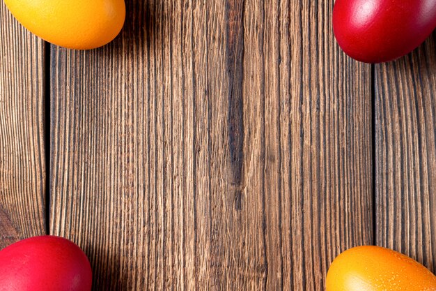 Colorful eggs for Easter on brown wooden  with copy space