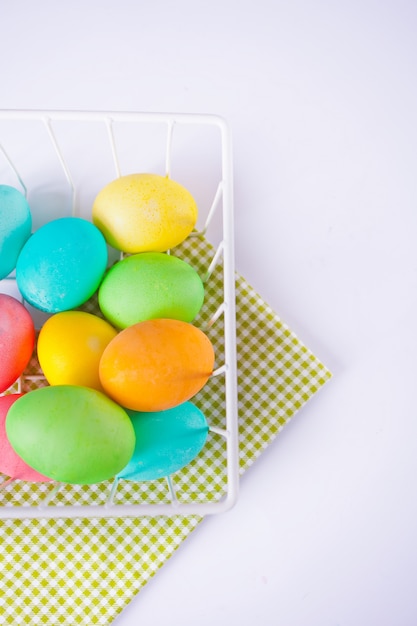 Colorful eggs for Easter day in a basket.