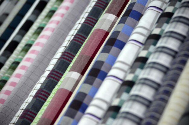 Colorful fabric samples on a shelf in a store close up