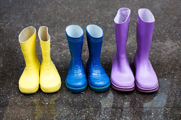 Premium Photo | Colorful family boots at rainy day on street