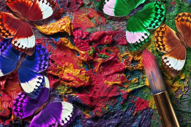 a colorful feather is laying on a rug with other things.