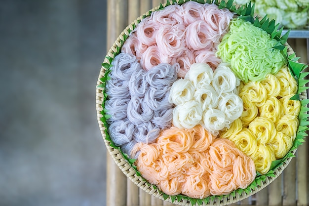 Colorful fermented rice flour noodles in bamboo basket ready to eat