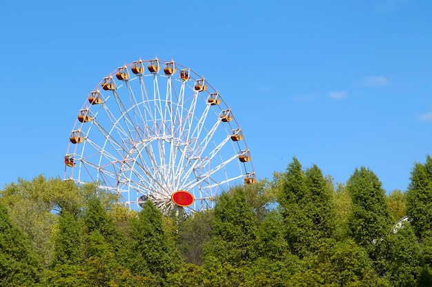 Colorful ferris wheel on blue sky background