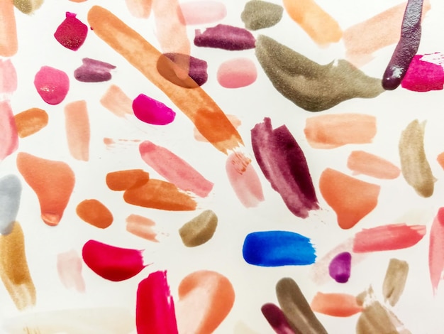 Colorful fingernail paint of customer testing on white paper background