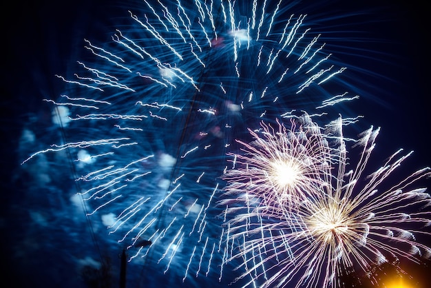 Colorful fireworks on background night sky. The explosions of the salute at festival