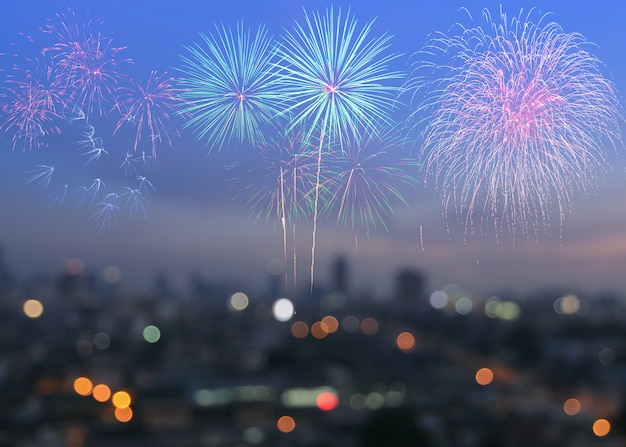 Colorful fireworks on blur city skyline background at twilight