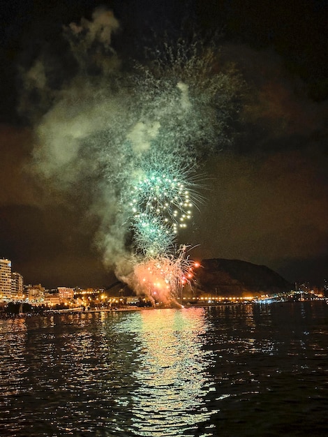 Colorful fireworks in the night sky on the seafront of alicante spain