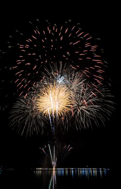 Colorful fireworks with reflection on lake 