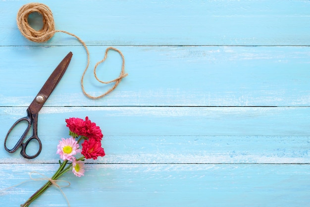 Colorful flowers bouquet on blue wooden background.  