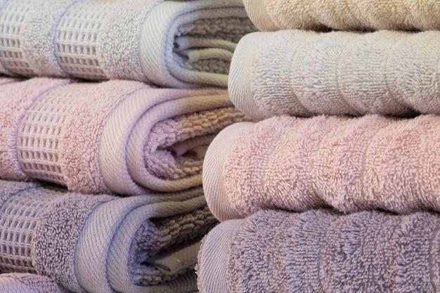 Colorful folded towels stack closeup picture.