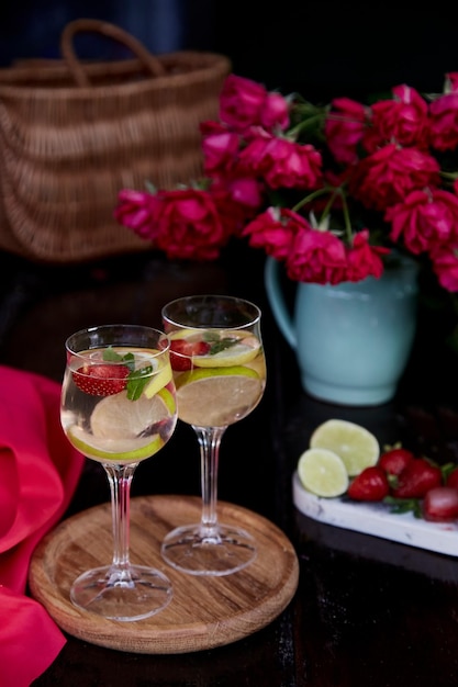 Colorful fortified water infused water with lemon lime mint and strawberries Bright summer healthy natural summer cocktails Refreshing diet detox natural water Summertime aesthetic