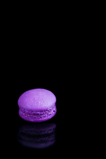 Colorful french macaroons on a black background.