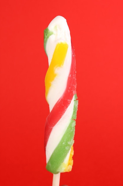 Colorful fruit juice ice on red background