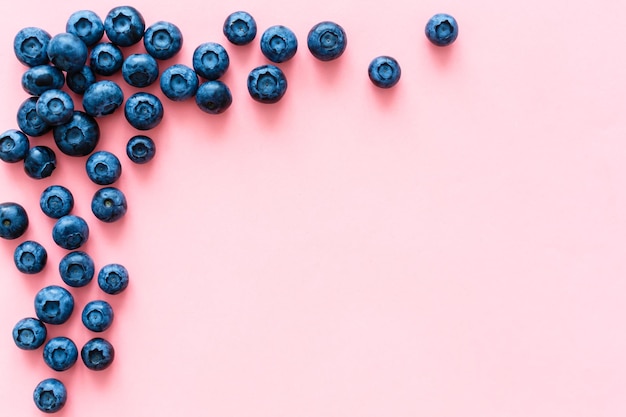 Colorful fruit pattern of blueberries on pink background. Top view. Flat lay