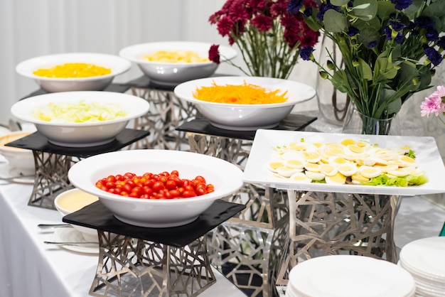 Colorful fruit and small cakes arranged in the buffet corner ready to eat