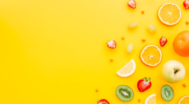 Photo colorful fruit on yellow background