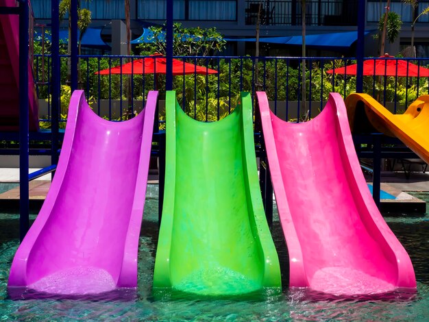 Colorful fun water slider in the pool with clear and clean water