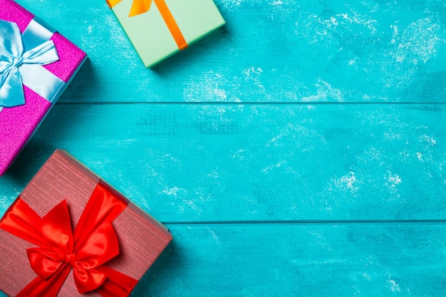 Colorful gift boxes on blue wooden background