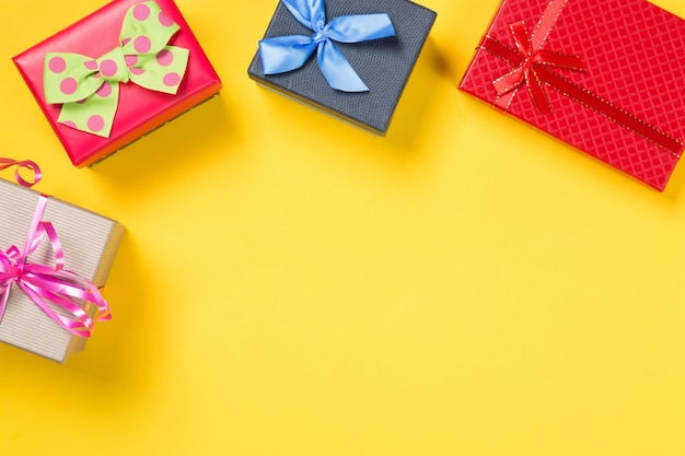 Colorful gift boxes on yellow  background