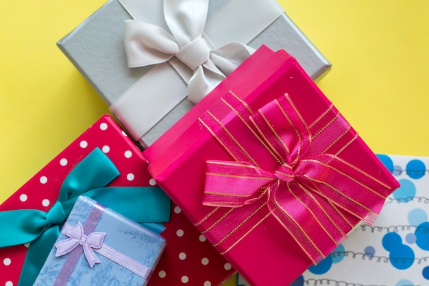 Colorful gift surprise packages, on pink background.