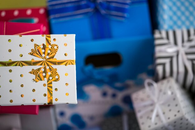 Colorful gift surprise packages, on pink background.