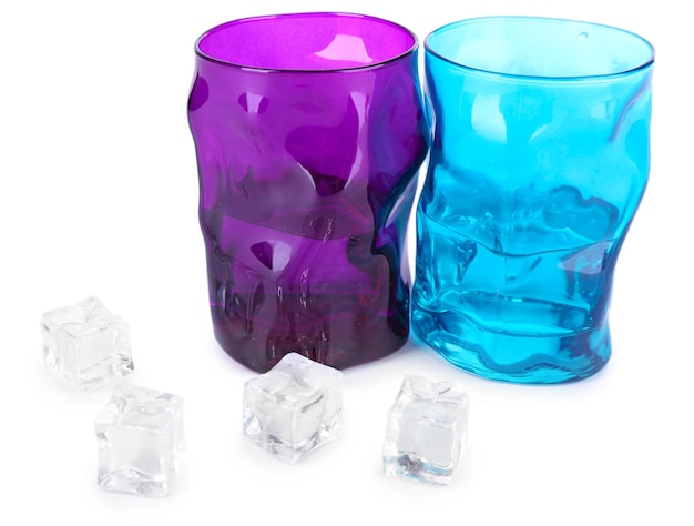 Colorful glasses and ice cubes isolated on white